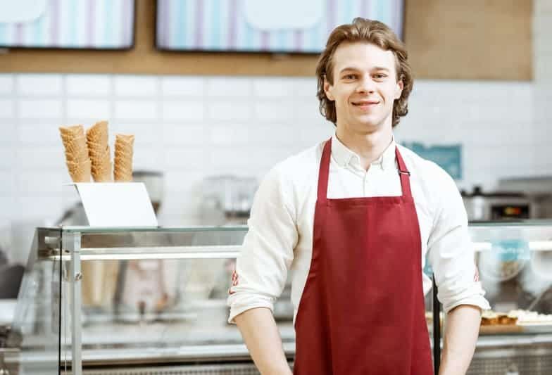 Handsome teenage boy wearing a red apron working in the best ice cream shop in Jacksonville, San Marco Dreamette located at 1905 Hendricks Ave. Jacksonville, FL 32207